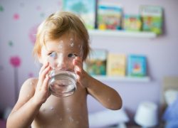 Young Australian child drinking water from Sydney's PFAs contaminated water supply