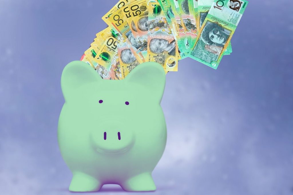 Money into green piggy bank. Sydneysiders can save on new solar hot water systems through government rebates.